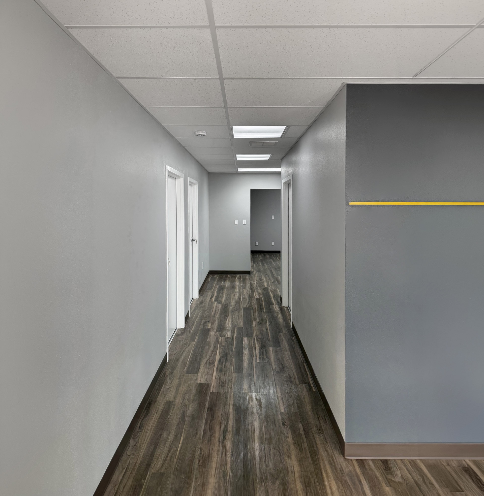 Financial Institution -- finished hallway with door installations and LVT flooring