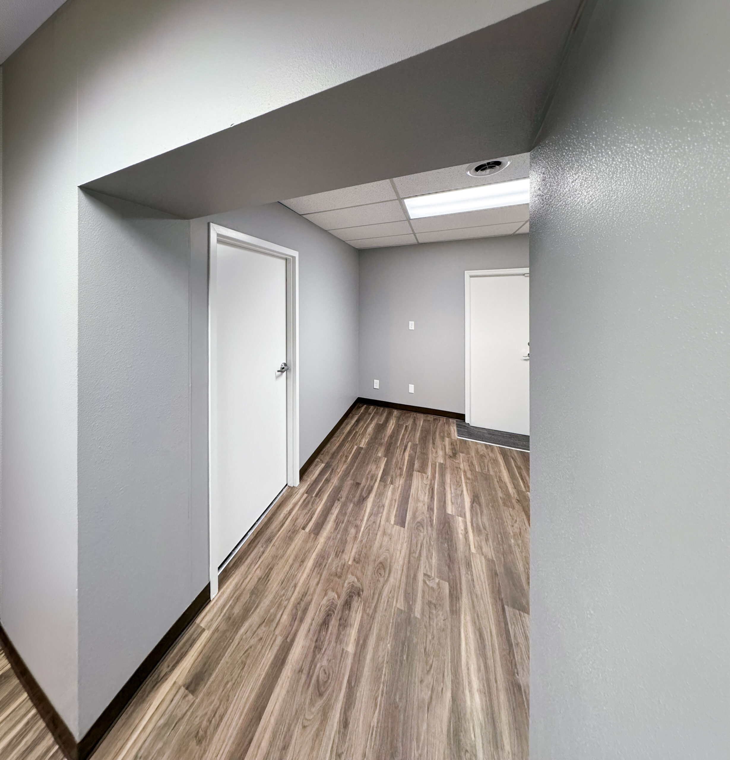 Financial Institution -- entry corridor with LVT flooring and door hardware